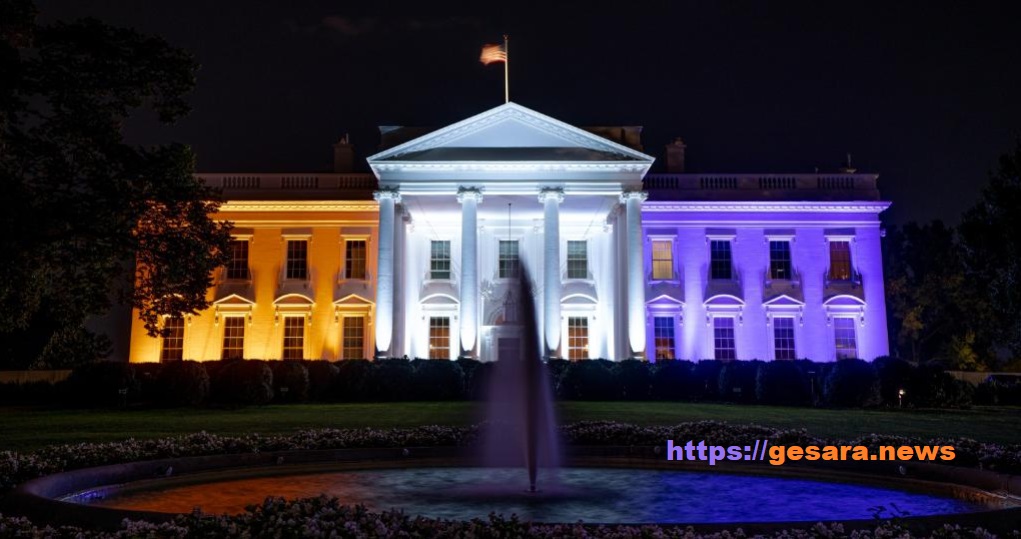 White House illuminated in purple and gold